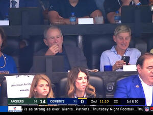 TV host Ellen DeGeneres with the former president of the United States George Bush at an American Football game in Texas.