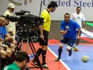 Kuwaiti Parliament Speaker Marzouq al-Ghanim (R) fights for the ball during a friendly indoors football match between members of Kuwait's cabinet and parliament in Kuwait City on May 18, 2019. 