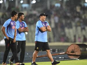 Bangladesh cricket coach Russell Domingo (R), Mosaddek Hossain (C) and Mohammad Saifuddin walk over the field