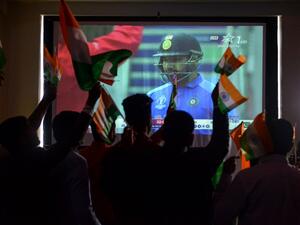 Indian cricket fans react as they watch a live broadcast of the Cricket World Cup match between India and Pakistan at a hotel in Amritsar on June 16, 2019. 