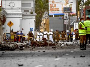 Sri Lankan priests look at the debris of a car after it explodes when police tried to defuse a bomb near St. Anthony's Shrine in Colombo on April 22, 2019. (AFP/ File)