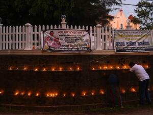Relatives light a coconut oil lamps and pray for the victims of Easter sunday bomb blasts at St. Sebastian's Church in Negombo, near Colombo on May 4, 2019. (AFP)