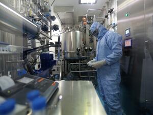 Pharmaceutical factory workers dressed in chemical safety suits work in the bioreactor room at the Actoverco plant in Karaj, about 40 kilometres (nearly 25 miles) west of Iran's capital Tehran, on February 18, 2020. AFP