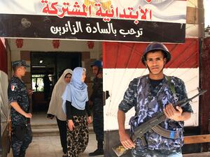 Egyptian security forces stand guard outside a polling station in the Mediterranean port city of Alexandria, where locals were voting in a referendum on constitutional amendments. (AFP/ File Photo)