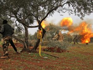 Members of Syria's opposition "National Liberation Front" fire heavy artillery guns at government forces in the village of Talhiyeh near the town Taftanaz in northeastern Idlib province, from another position on February 28, 2020. Abdulwajed HAJ ESTEIFI / AFP