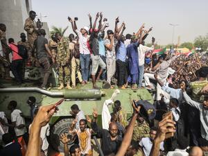 Sudanese anti-regime demonstrators stand on an army armoured military vehicle on April 11, 2019. (AFP/ File Photo)