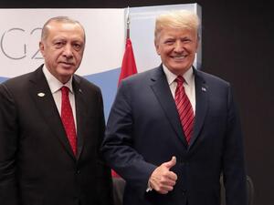 Turkey's President Recep Tayyip Erdogan, left, with US President Donald Trump at G20 summit in Buenos Aires, Argentina, on 1 December (AFP)