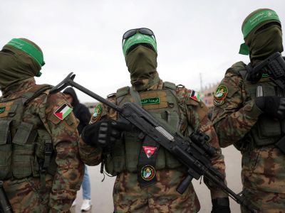 Palestinian Hamas fighters gather at the site of the handing over of Israeli hostages at the Nuseirat refugee camp in the central Gaza Strip as part of the seventh hostage-prisoner release on February 22, 2025. Photo by BASHAR TALEB / AFP Palestinian Hamas fighters