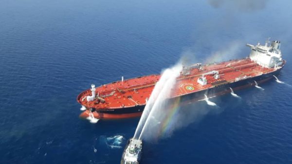 An Iranian navy boat tries to stop the fire of an oil tanker after it was attacked in the Gulf of Oman. 