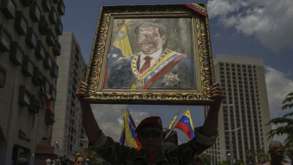 A government supporter attends a rally in the surroundings of Miraflores Presidential Palace in Caracas on May 20, 2019 to mark one year anniversary of Venezuela's President Nicolas Maduro's re-election. (Federico PARRA / AFP)