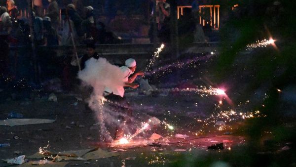 Indonesian protesters throw stones at riot police during a demonstration against the re-election of Indonesian president in Jakarta on May 22, 2019. (AFP/ File)