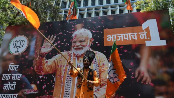 An Indian supporter of Indian Prime Minister Narendra Modi's Bharatiya Janata Party (BJP) celebrates the election results outside the BJP headquarters in Mumbai on May 23, 2019. (AFP/ File Photo)