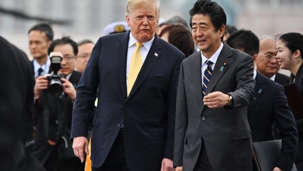 US President Donald Trump (L) walks with Japan's Prime Minister Shinzo Abe as he leaves Japan's navy ship Kaga in Yokosuka on May 28, 2019. (Charly TRIBALLEAU / POOL / AFP)
