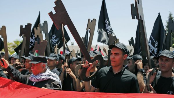 Palestinians hold up paper cutouts of keys as they take part in a rally marking the 71st anniversary of the 'Nakba', or catastrophe, on May 15, 2019 in Ramallah. (AFP)