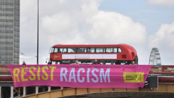Banners created by UK based human rights organisation Amnesty International and unfurled over Vauxhall Bridge in central London on June 3, 2019 to coincide with the UK State Visit of US President Donald Trump and US First Lady Melania Trump. (AFP)