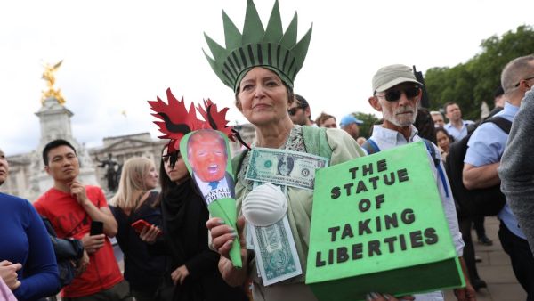 A woman protests outside Buckingham Palace in central London on June 3, 2019, on the first day of the US Presidential three-day State Visit to the UK. (AFP/ File)