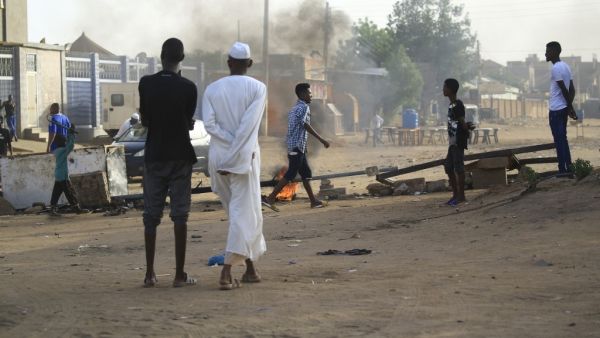 Locals set tyres on fire and block a sidestreet leading to their neighbourhood in the Sudanese capital Khartoum to stop military vehicles from driving through the area on June 4, 2019.. (AFP)