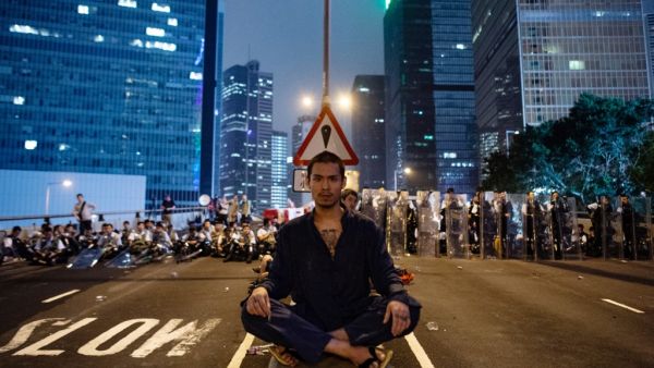 A protester (C) sits at the middle of Harcourt Road in Hong Kong after a protest against a controversial extradition law proposal in Hong Kong on June 12, 2019. (AFP/ File)