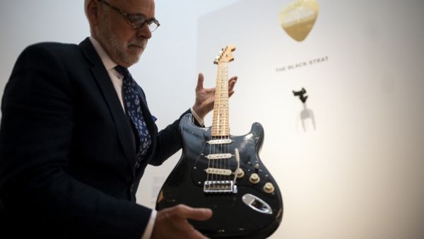 Kerry Keane, Christie's Musical Instruments Specialist holds the "Black Strat" (Fender Stratocaster, 1969) from David Gilmour at Christie's on June 14, 2019 in New York City. (AFP)