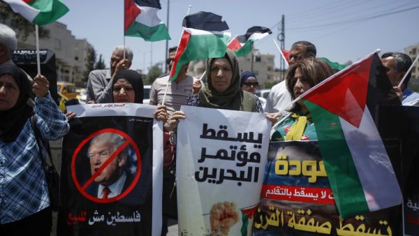 Palestinians hold banners and shout slogans as they rally against the US-led Israeli-Palestinian peace conference in Bahrain scheduled for next week, in Bethlehem in the occupied West Bank on June 20, 2019. (Musa AL SHAER / AFP) Palestinians hold banners and shout slogans as they rally against the US-led Israeli-Palestinian peace conference in Bahrain scheduled for next week, in Bethlehem in the occupied West Bank on June 20, 2019. (Musa AL SHAER / AFP)