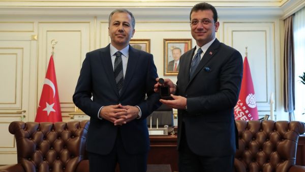 Istanbul's new mayor Ekrem Imamoglu (R) poses with Istanbul's Governor and acting Mayor Ali Yerlikaya during a handover ceremony at the Town Hall in Istanbul, on June 27, 2019.  CAN EROK / POOL / AFP