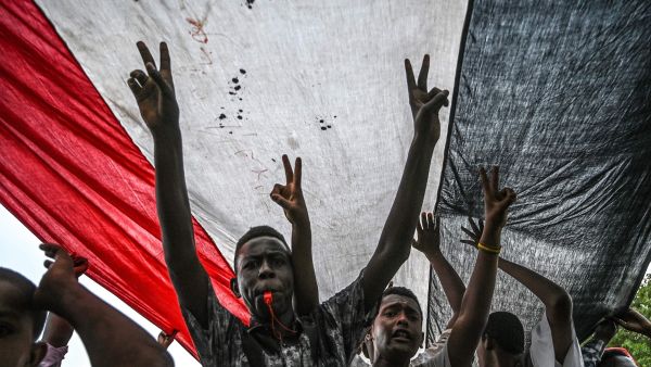 Sudanese protesters shout slogans and flash victory signs during a rally outside the army complex in Sudan's capital Khartoum. (AFP/ File Photo) Sudanese protesters shout slogans and flash victory signs during a rally outside the army complex in Sudan's capital Khartoum. (AFP/ File Photo)