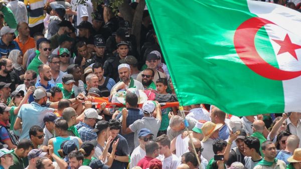 Thousands of people protested for a twentieth consecutive week in Algeria's capital, defying a major police presence just days before the mandate of interim president Bensalah expires. (AFP/ File Photo)