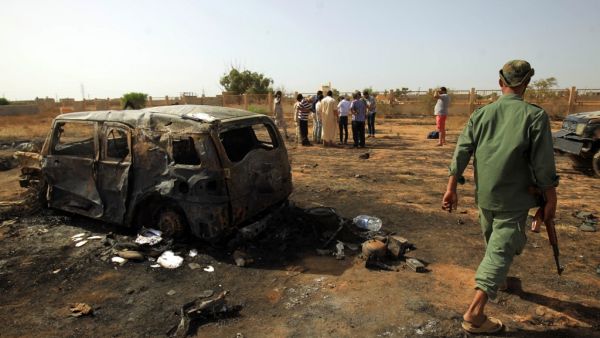 Libyans inspect the site of a car bomb attack that targeted servicemen during the funeral of an ex-army commander in the Libyan city of Benghazi, on July 11, 2019. (AFP/ File Photo)