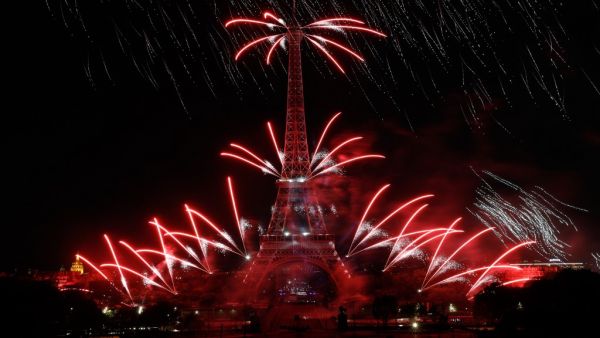 Fireworks explode from the Eiffel Tower and above the Trocadero Gardens as part of the annual Bastille Day celebrations in Paris on July 14, 2019. (GEOFFROY VAN DER HASSELT / AFP)