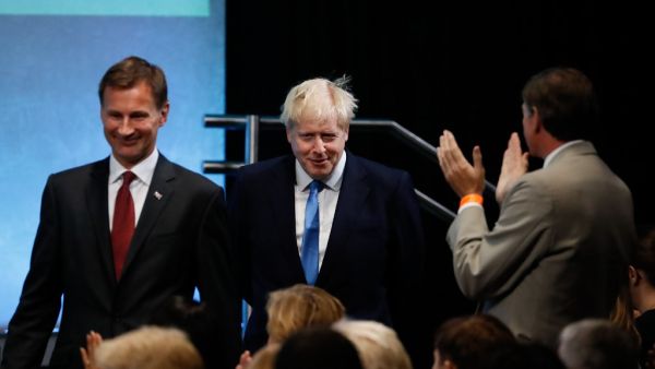 Conservative Party leadership candidates Jeremy Hunt (L) and Boris Johnson (C) arrive in the auditorium at an event to announce the winner of the Conservative Party leadership contest in central London on July 23, 2019. (Tolga AKMEN / AFP)