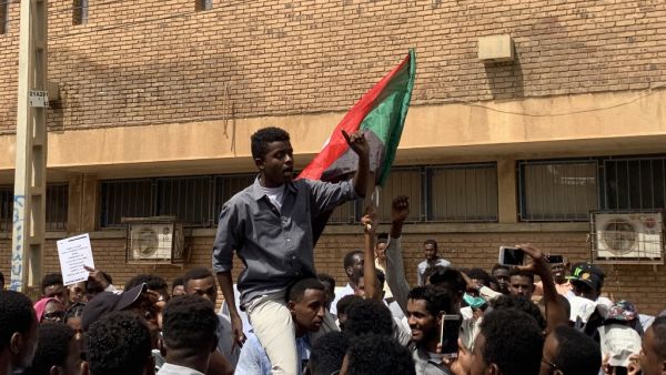 A Sudanese protester is lifted on the shoulders of another while chanting slogans during a demonstration commemorating protesters killed during past clashes, in the centre of the capital Khartoum on July 23, 2019.  Haitham EL-TABEI / AFP