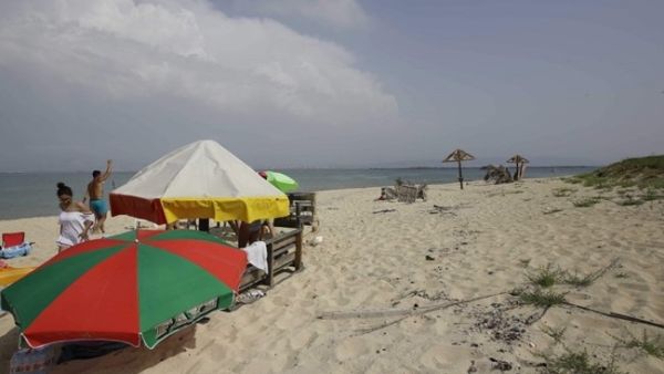 People enjoy a day on the Palm Island natural reserve near the coast of the Mina district of Tripoli in northern Lebanon on May 27, 2018. ( AFP / IBRAHIM CHALHOUB)