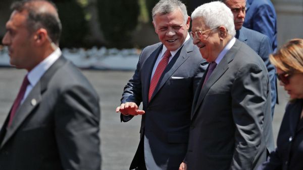 Jordan's King Abdullah II, center, walks Monday with Palestinian leader Mahmoud Abbas. (AHMAD GHARABLI/Getty-AFP )