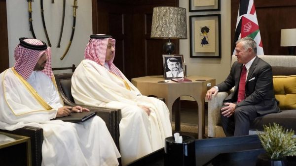 King Abdullah II, right, receiving Qatar's Deputy Prime Minister Khalid bin Mohammed Al-Attiyah, centre, in Amman on 17 April (AFP)