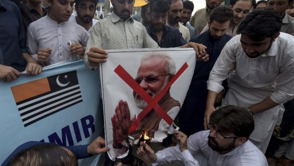 Students of Islami Jamiat-e-Talaba (IJT), a wing of religious political party Pakistan Jamaat-e-Islami (JI), burn a photograph of Indian Prime Minister Narendra Modi during a protest in Peshawar (AFP)