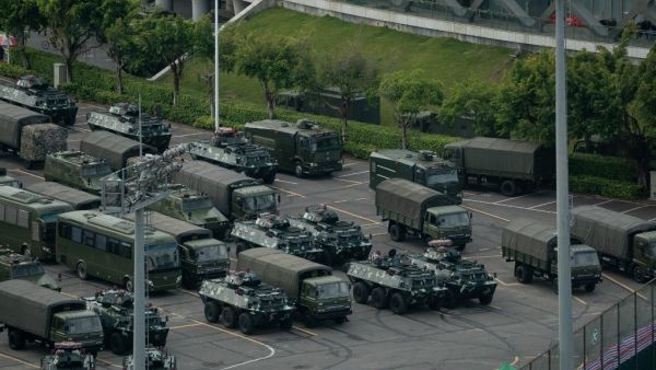 Trucks and armoured personnel carriers are seen parked at the Shenzhen Bay stadium in Shenzhen, bordering Hong Kong in China's southern Guangdong province, on August 16, 2019. (AFP)
