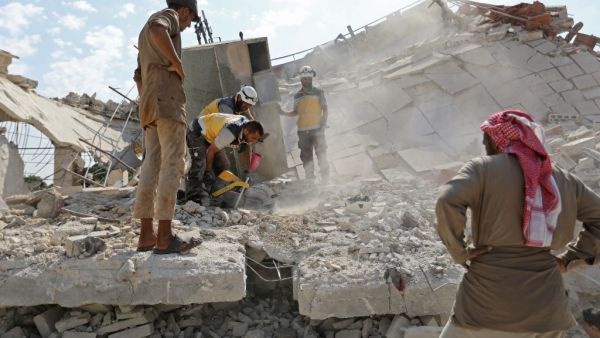 Members of the Syrian Civil Defence (White Helmets) search for victims amidst the rubble of a building that collapsed during reported air strikes by pro-regime forces in the village of Beinin, north of Maaret al-Numan, in the northern Idlib province, on August 20, 2019. (AFP/ File Photo)