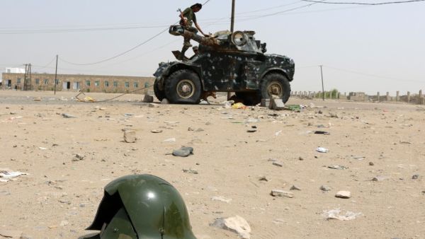 A Fighter stands atop a military vehicle in Yemen (AFP)