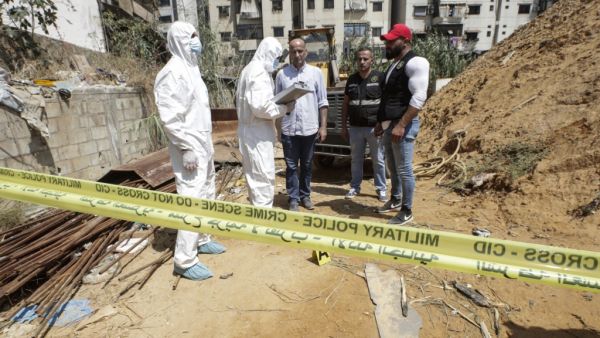 Forensic investigators of Lebanon's military intelligence inspecting the scene where two drones came down in the vicinity of a media centre of the Shiite Hezbollah movement earlier in the day in the south of the capital Beirut. (AFP/ File Photo)