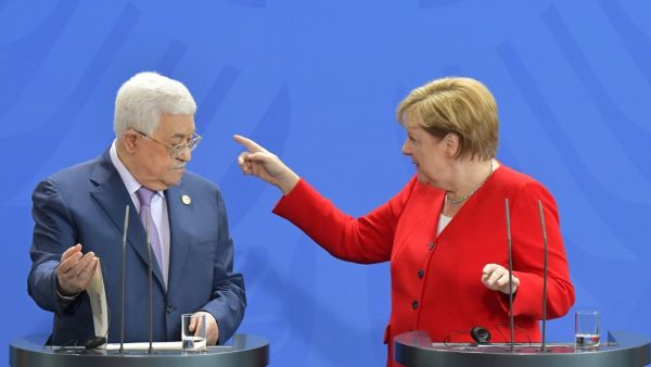 German Chancellor Angela Merkel points the way to Palestinian President Mahmud Abbas after a making a press statement before talks in Berlin on August 29, 2019.  Tobias SCHWARZ / AFP