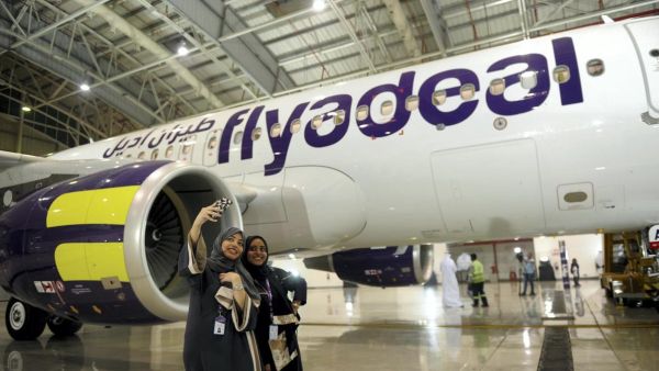 Female cabin crew pose in front of a flyadeal aircraft. (AFP)