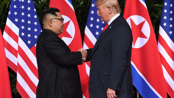 North Korean leader Kim Jong Un shakes hands with US President Donald Trump at the start of their summit in Singapore on Tuesday, June 12. (Saul Loeb/AFP/Getty Images)