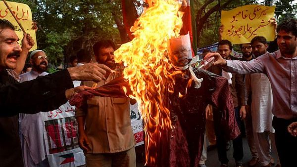 Protesters burn an effigy of Indian Prime Minister Narendra Modi during a protest in Lahore, Pakistan, where Muslims supported Kashmir's claim to special status  (AFP)