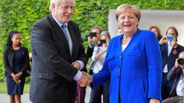 Boris Johnson was greeted by Angela Merkel in Berlin this afternoon as he arrived in Germany for showdown Brexit talks (AFP/ File Photo)