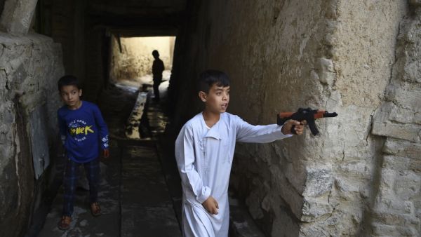 Afghan children play with plastic toy guns (AFP)