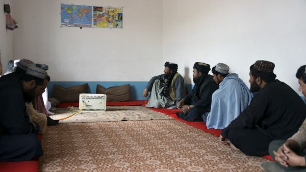 In this picture taken on August 15, 2019, Mohammad Manzoor Hussaini (C back), who previously fought for the Taliban, speaks during an interview with AFP in Kandahar. (AFP/ File Photo)