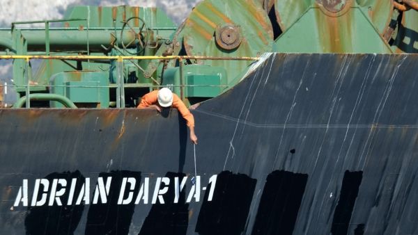 A crew member checks the new name of Iranian oil tanker Adrian Darya, formerly known as Grace 1, off the coast of Gibraltar. The United States on August 30, 2019. (AFP/ File Photo)