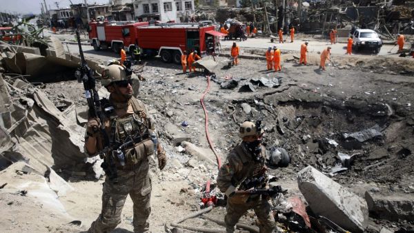 Afghan security forces walks as municipal workers gather to clean up near the crater from where a tractor packed with explosives exploded the night before at the Green Village in Kabul on September 3, 2019. (AFP/ File Photo)