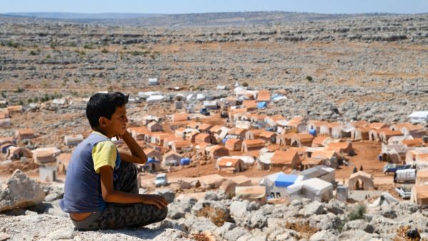 A young Syrian boy who was displaced from the town of Khan Sheikhoun, gazes from a small hilltop on September 8, 2019. (AFP/ File Photo)
