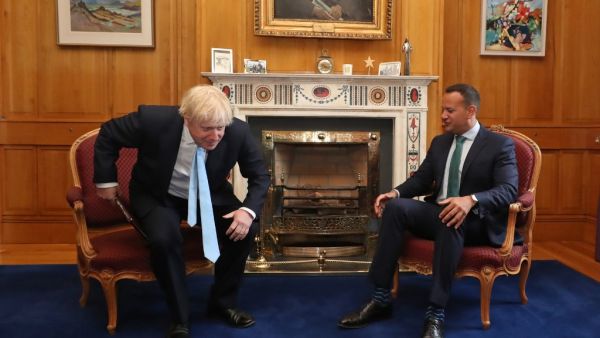 Britain's Prime Minister Boris Johnson (L) rises from his chair after posing for a photograph with Irish Prime Minister Leo Varadkar (R) (AFP)